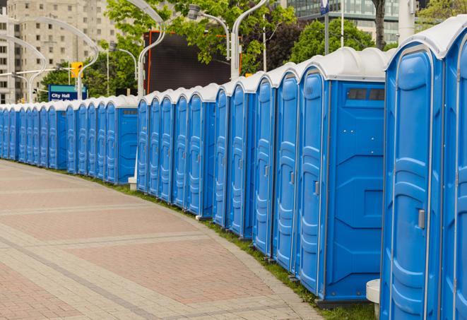 portable restrooms stationed outside of a high-profile event, with attendants available for assistance in Bingham Farms